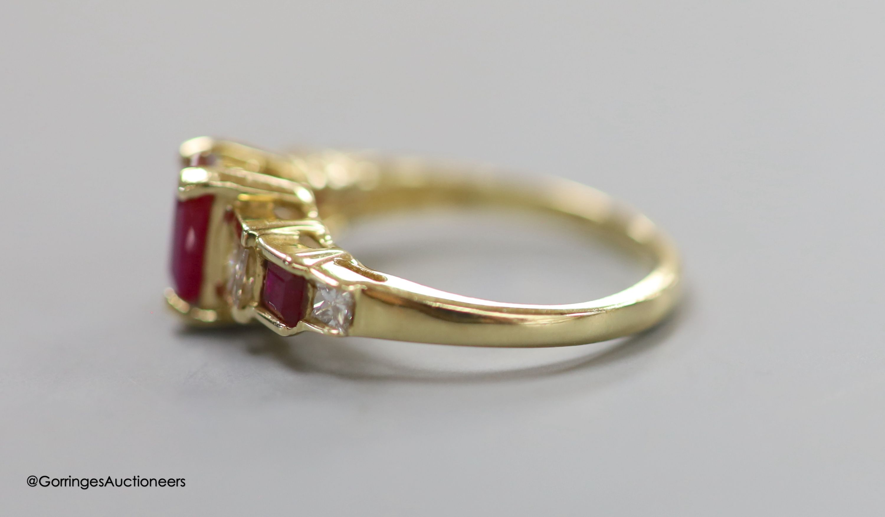 A modern 14k, ruby and graduated ruby and diamond set seven stone half hoop ring, size N, gross 3.6 grams.